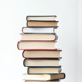 Stack of books or documents, representing resources.